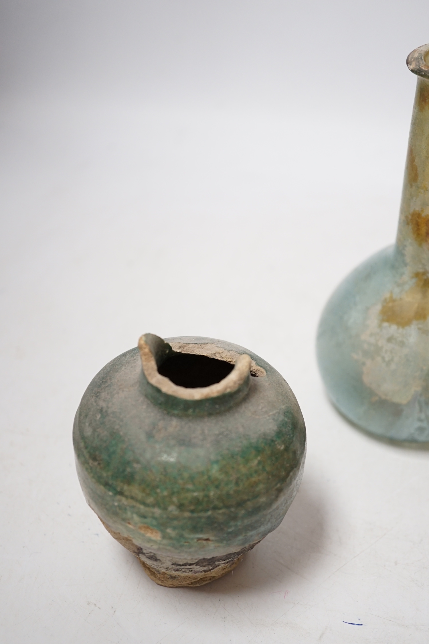 A Roman glass vessel, an Islamic pot and oil lamp, largest 18cm high (3)